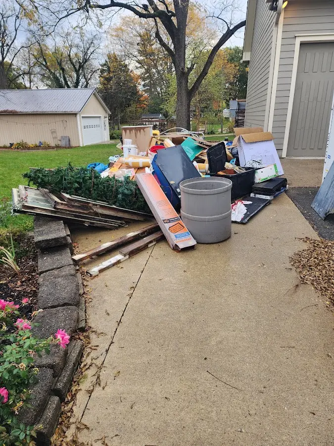 Dumpster being loaded with debris for Residential Dumpster Rental in Thompson